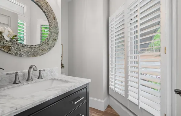 a view of a backyard with table and chairs and potted plants
