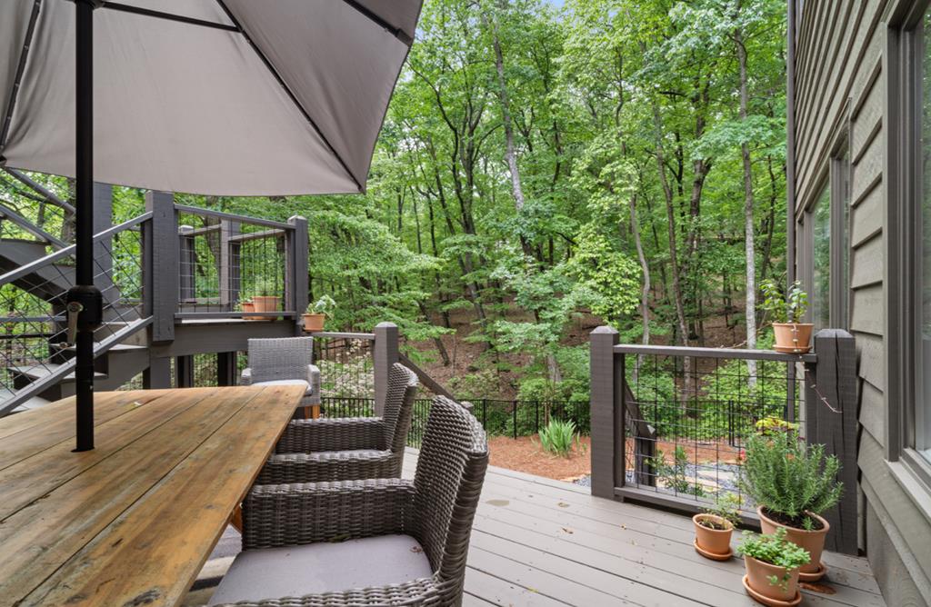 220 Wake Robin Drive Jasper, GA 30143 - Photo 62 of 81 a view of a patio with couches table and chairs under an umbrella