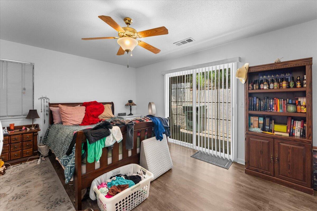 726 Stonebriar Trail Redding, CA 96003 - Photo 18 of 26 a bedroom with furniture and a book shelf