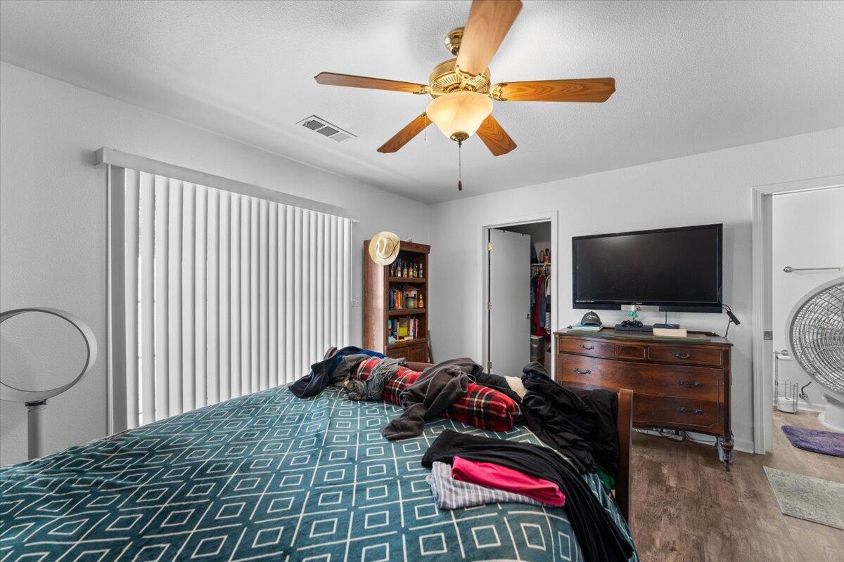 726 Stonebriar Trail Redding, CA 96003 - Photo 19 of 26 a bedroom with a bed and a flat screen tv