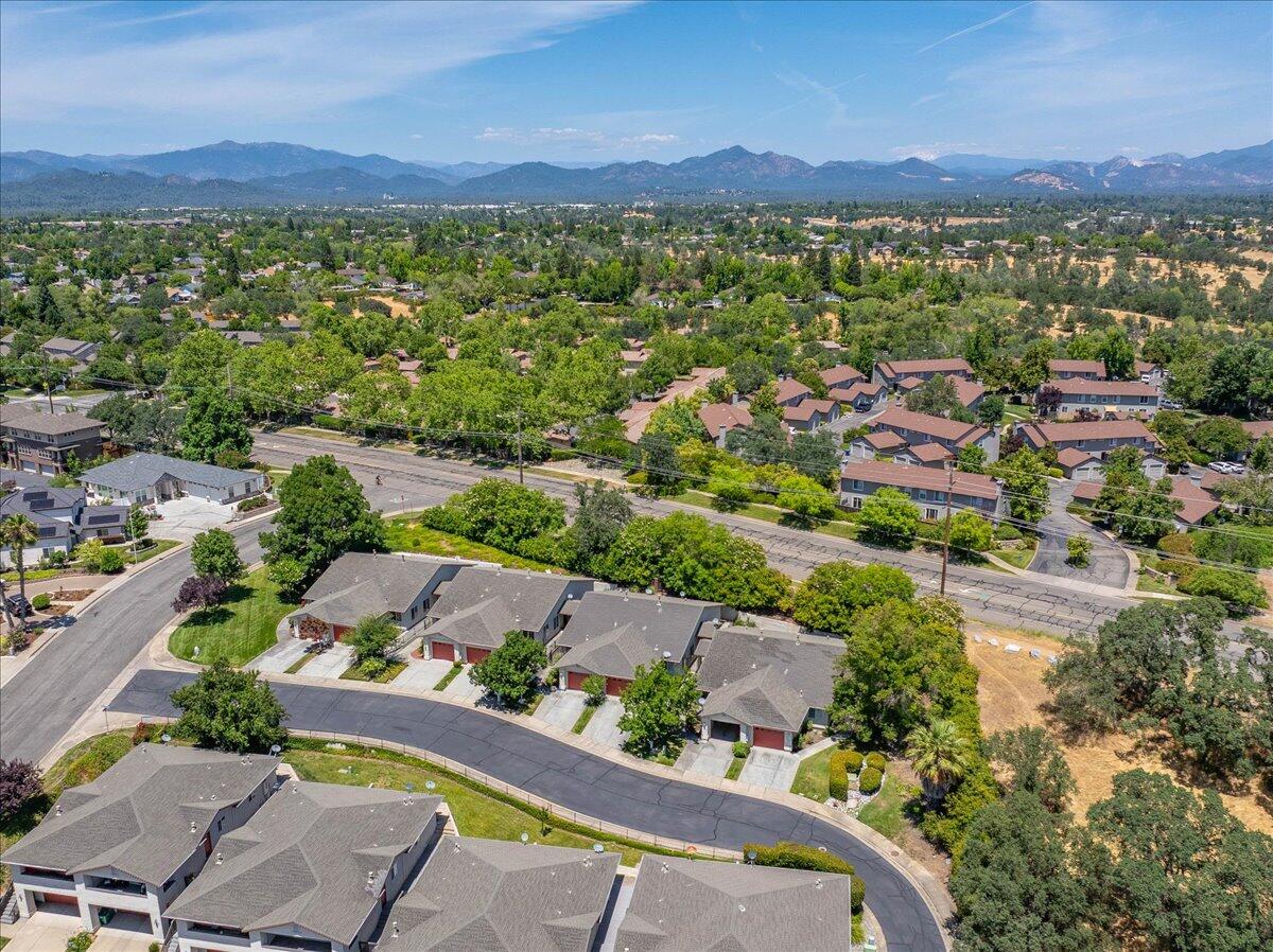 726 Stonebriar Trail Redding, CA 96003 - Photo 23 of 26 an aerial view of a city with lots of residential buildings and mountain view in back