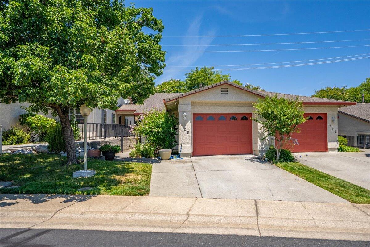 726 Stonebriar Trail Redding, CA 96003 - Photo 3 of 26 a front view of a house with a yard and garage