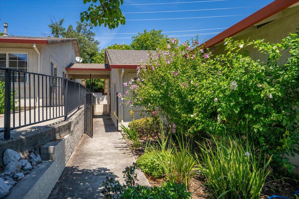 726 Stonebriar Trail Redding, CA 96003 - Photo 5 of 26 a view of a house with a small yard and plants