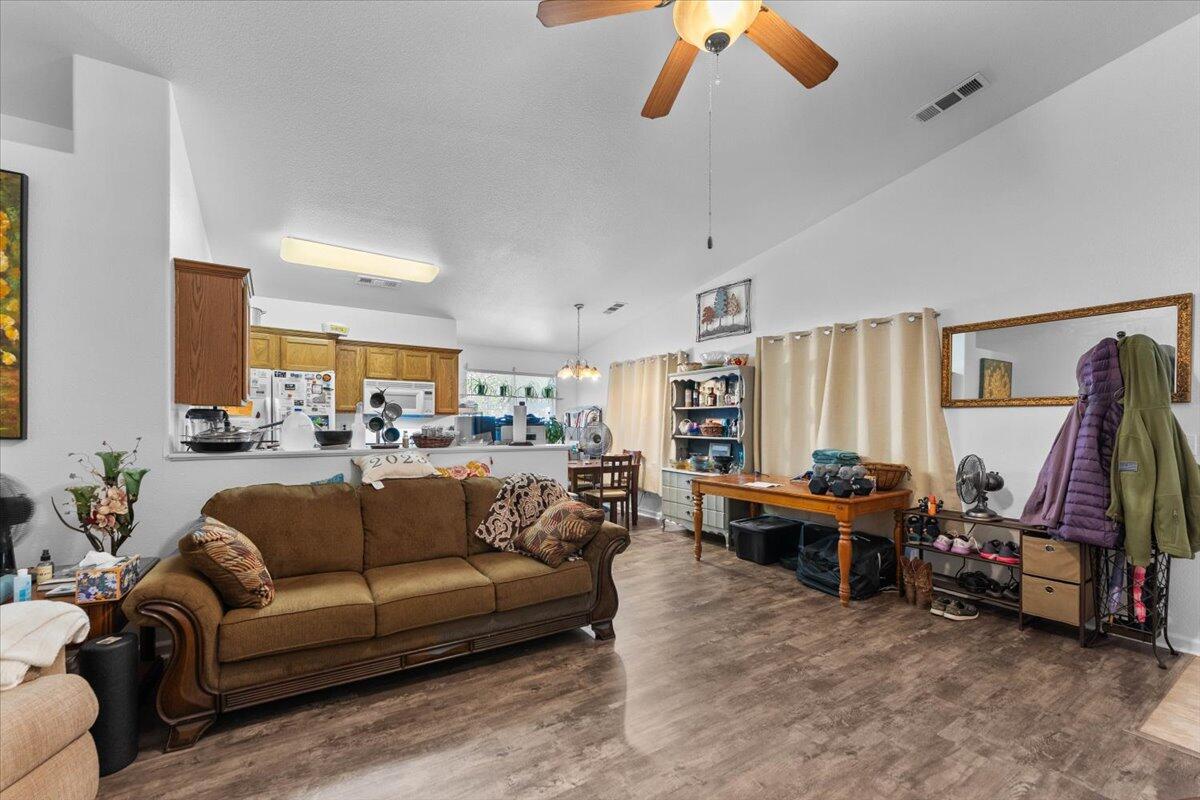 726 Stonebriar Trail Redding, CA 96003 - Photo 7 of 26 a living room with furniture and a flat screen tv