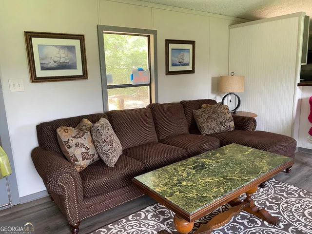 a living room with furniture and a rug
