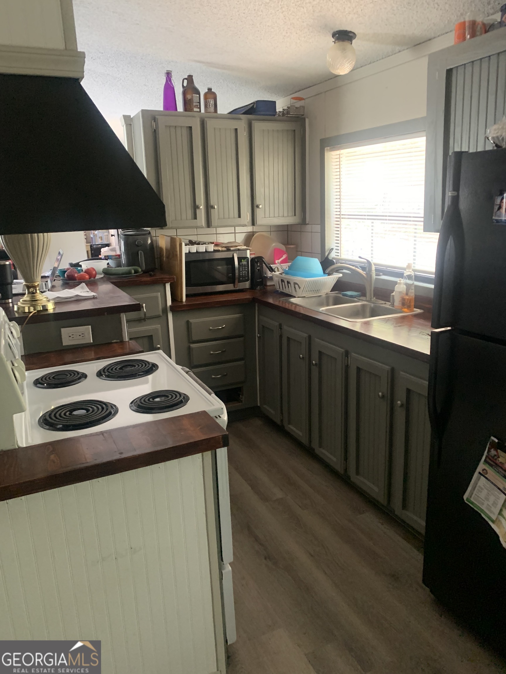 160 Scott Road Canton, GA 30115 - Photo 6 of 11 a kitchen with kitchen island granite countertop a sink stainless steel appliances a window and a counter