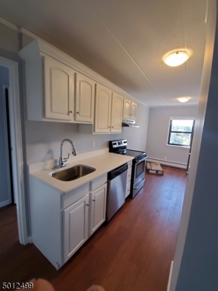 149 Main Street, Unit 3A Millburn, NJ 07041 - Photo 3 of 6 a kitchen with stainless steel appliances a sink stove and cabinets