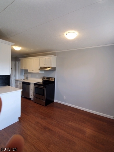 149 Main Street, Unit 3A Millburn, NJ 07041 - Photo 4 of 6 a kitchen with stainless steel appliances wooden floor and a refrigerator