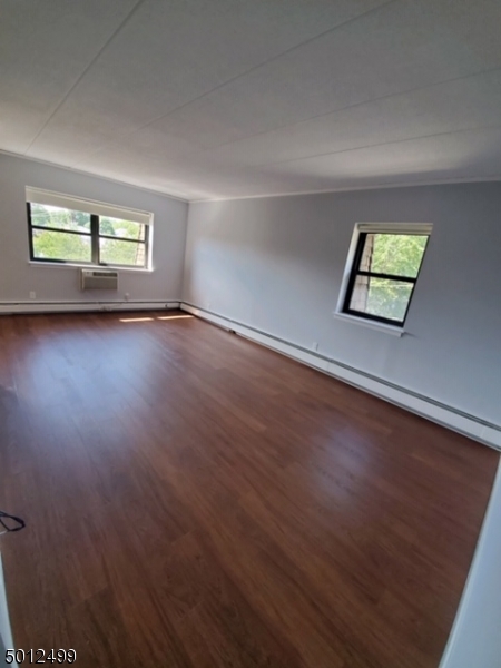 149 Main Street, Unit 3A Millburn, NJ 07041 - Photo 5 of 6 an empty room with wooden floor and windows
