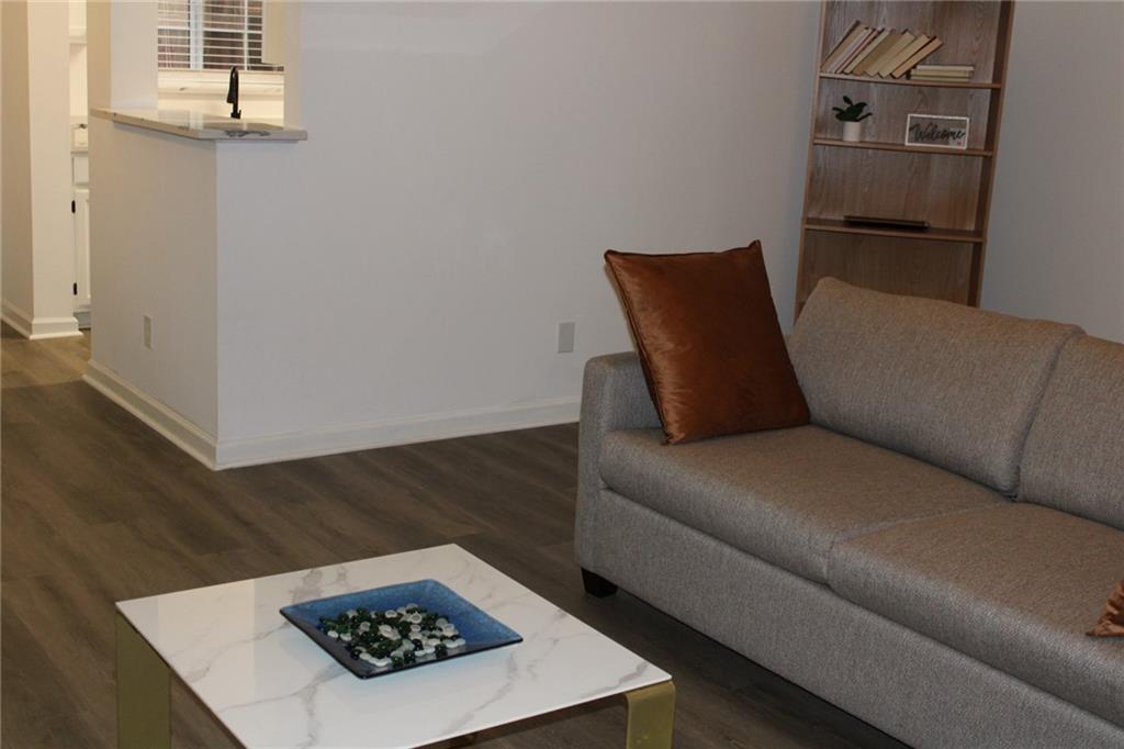 3389 Lochness Lane Powder Springs, GA 30127 - Photo 16 of 48 a living room with a couch