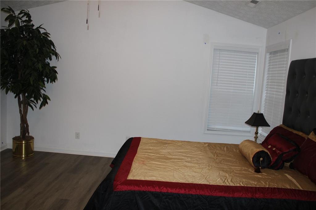 3389 Lochness Lane Powder Springs, GA 30127 - Photo 23 of 48 a bedroom with a bed and a flat screen tv