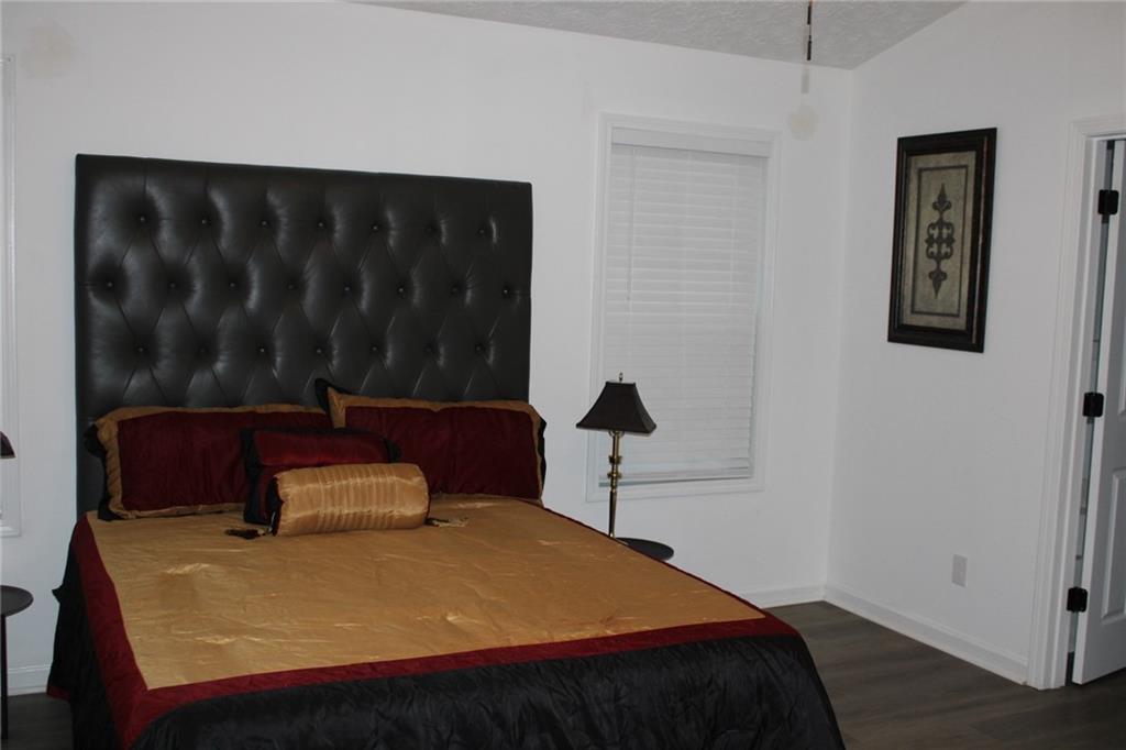 3389 Lochness Lane Powder Springs, GA 30127 - Photo 24 of 48 a bedroom with a bed and a dresser