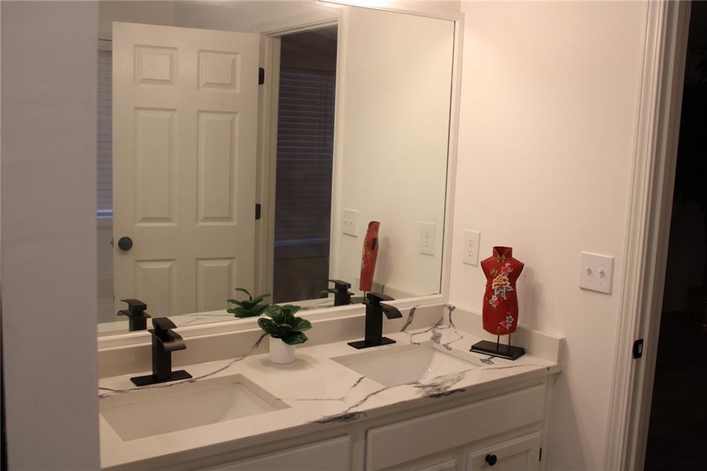 3389 Lochness Lane Powder Springs, GA 30127 - Photo 25 of 48 a bathroom with a sink and a mirror