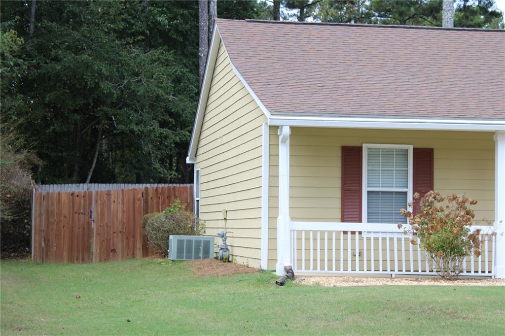 3389 Lochness Lane Powder Springs, GA 30127 - Photo 3 of 48 a view of house with backyard and a garden