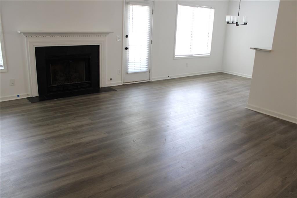 3389 Lochness Lane Powder Springs, GA 30127 - Photo 33 of 48 an empty room with wooden floor fireplace and windows