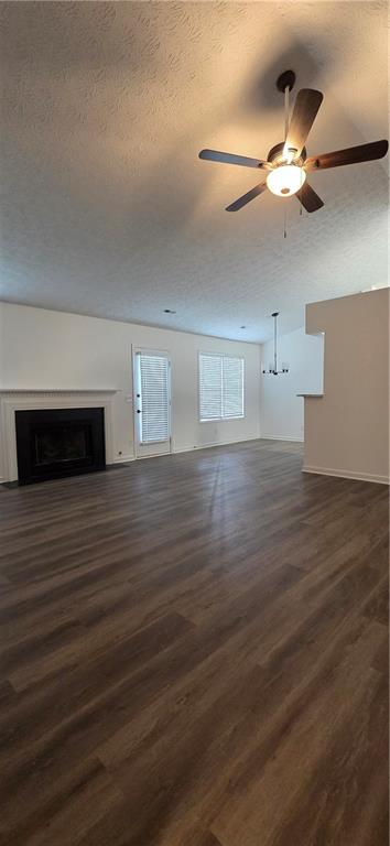 3389 Lochness Lane Powder Springs, GA 30127 - Photo 35 of 48 a view of an empty room with wooden floor and a ceiling fan
