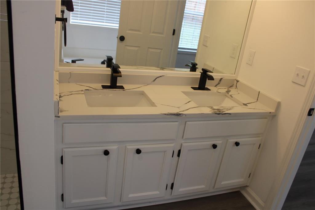 3389 Lochness Lane Powder Springs, GA 30127 - Photo 38 of 48 a bathroom with a sink and a mirror