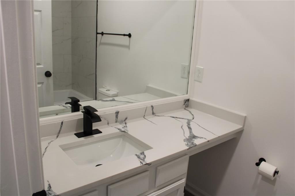 3389 Lochness Lane Powder Springs, GA 30127 - Photo 40 of 48 a bathroom with a sink and a mirror