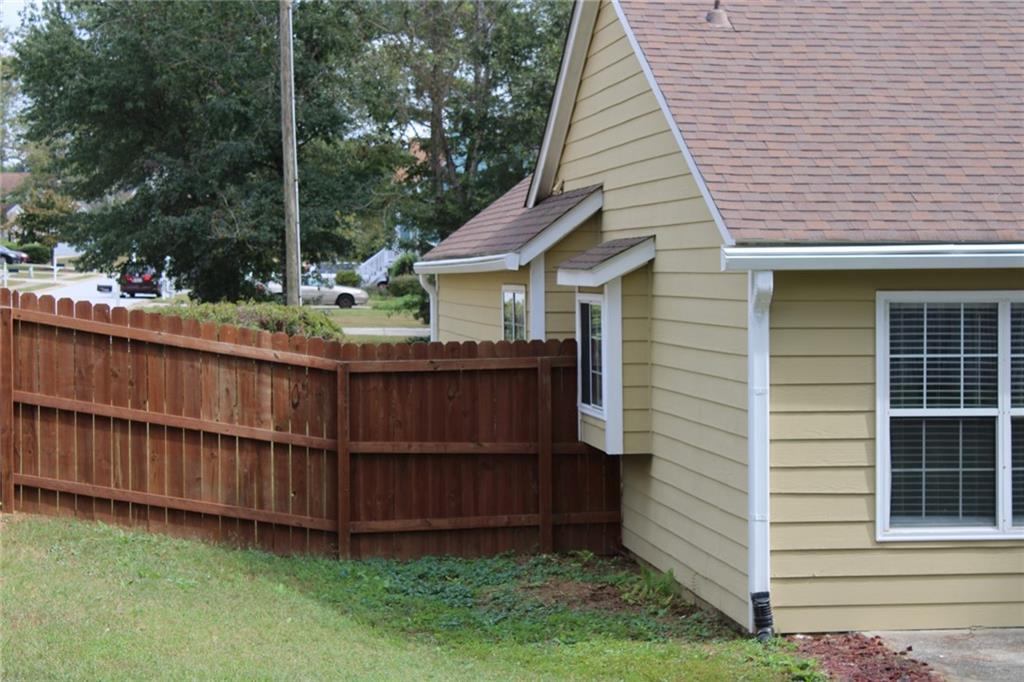 3389 Lochness Lane Powder Springs, GA 30127 - Photo 47 of 48 a view of a small house with a yard and wooden fence