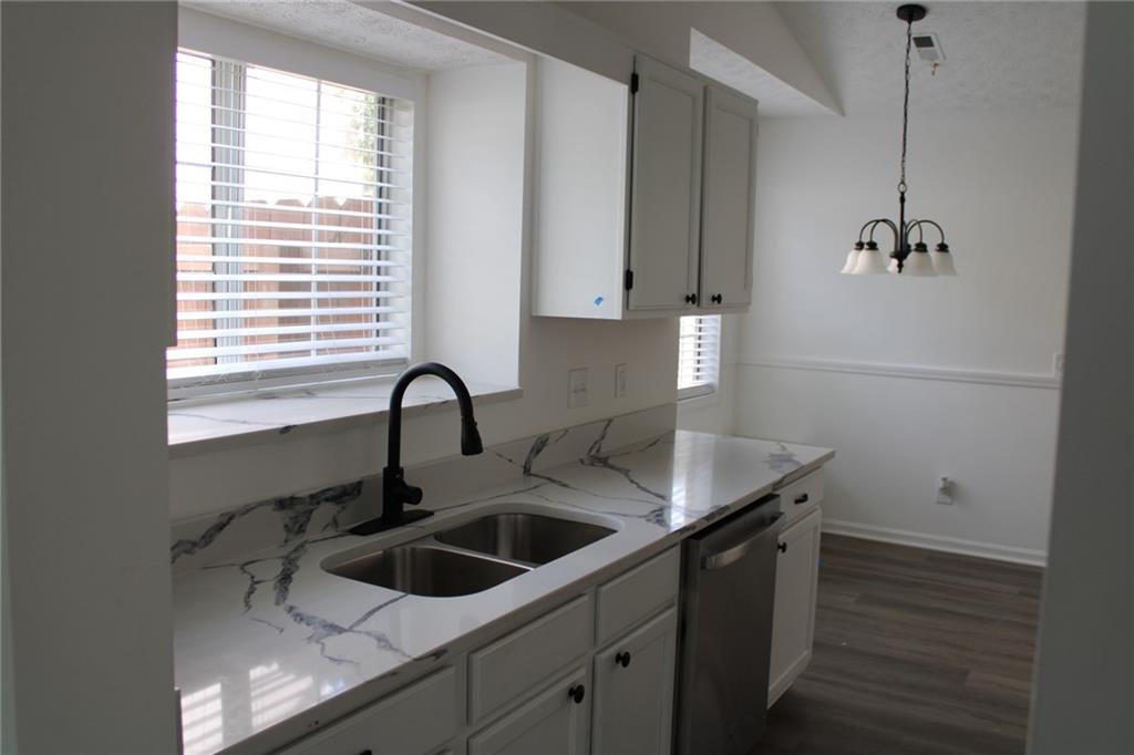 3389 Lochness Lane Powder Springs, GA 30127 - Photo 9 of 48 a kitchen with a sink cabinets and window