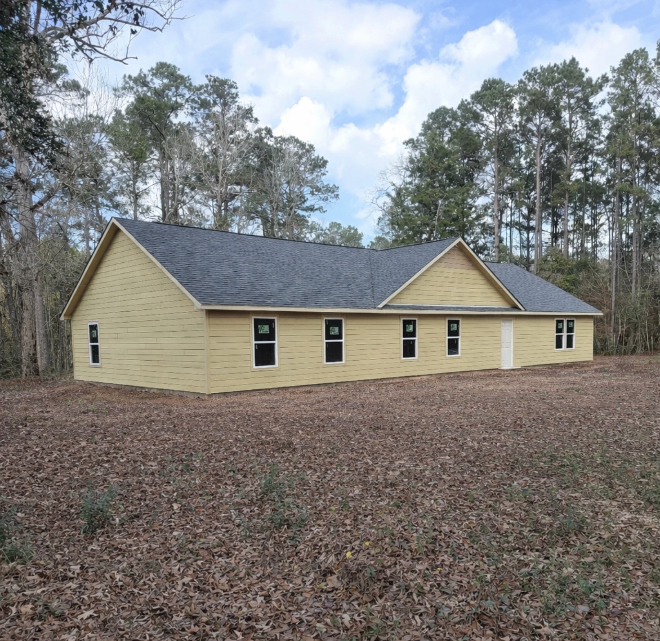 a house with green field in front of it
