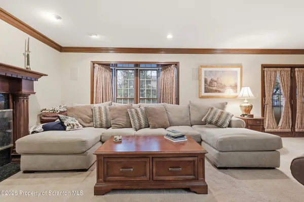 a living room with furniture a rug and a large window