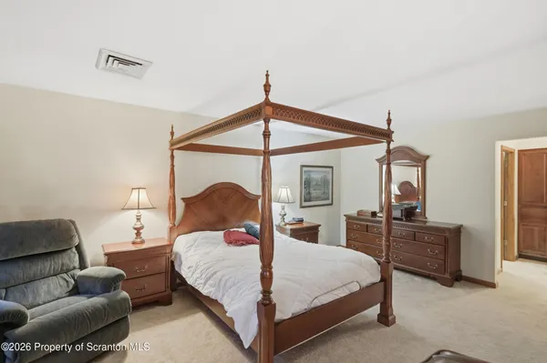 a bedroom with a bed and a night stand