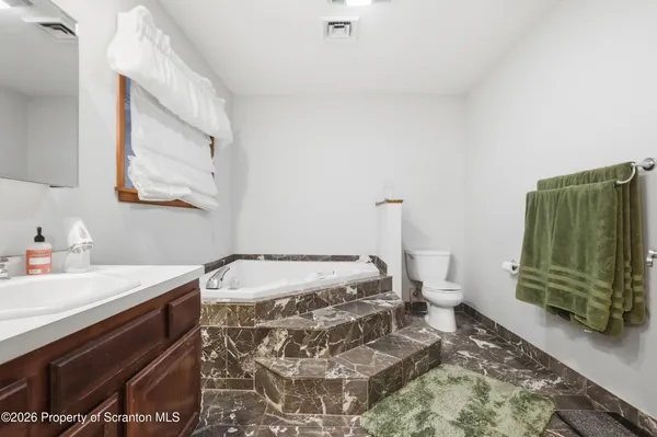 a living room with furniture kitchen view and a flat screen tv