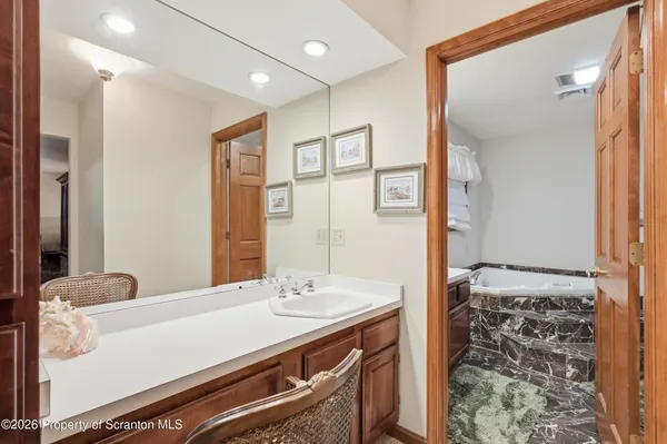 a living room with furniture a flat screen tv and a bookshelf
