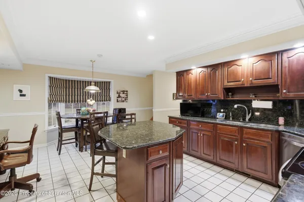 a white toilet sitting next to a white wall