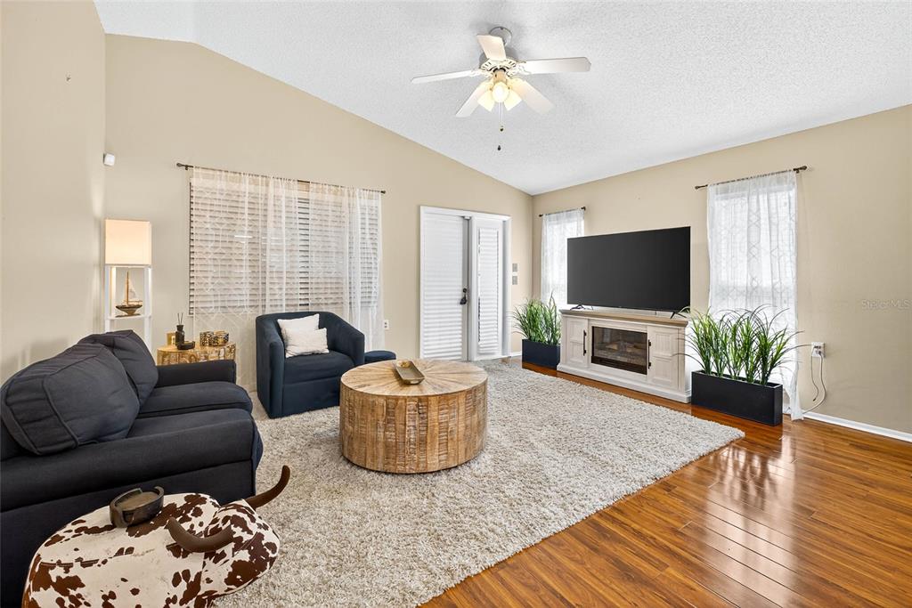 4658 Wallingford Court New Port Richey, FL 34655 - Photo 6 of 48 a living room with furniture a fireplace and a flat screen tv