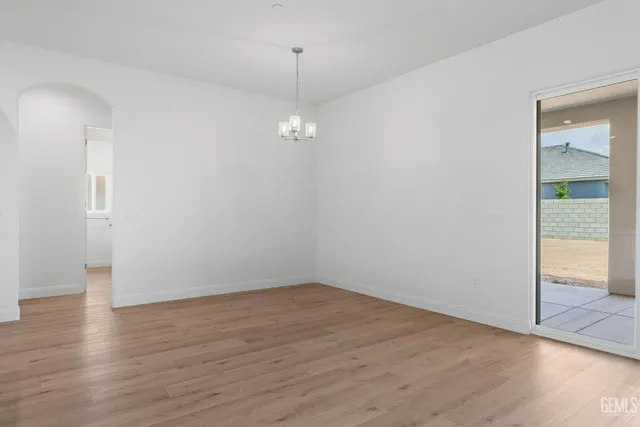 a large kitchen with stainless steel appliances granite countertop a large center island attached withe living room