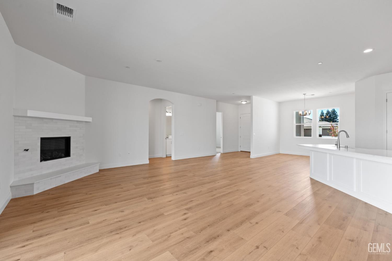 Undisclosed Address Bakersfield, CA 93314 - Photo 13 of 43 a view of empty room with wooden floor and fireplace