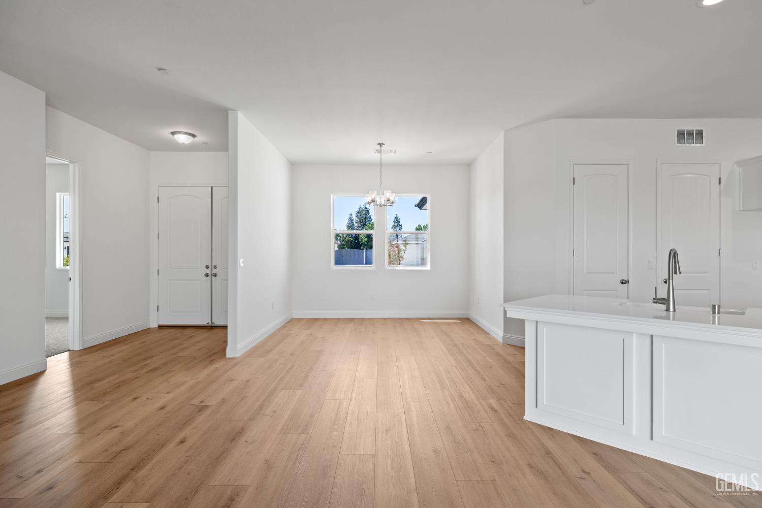 Undisclosed Address Bakersfield, CA 93314 - Photo 15 of 43 an empty room with wooden floor and windows