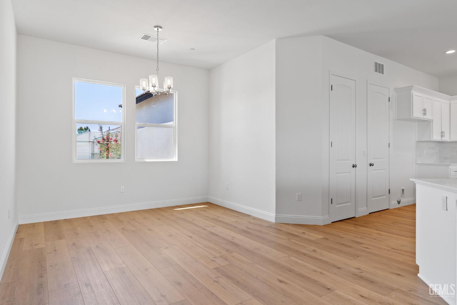 Undisclosed Address Bakersfield, CA 93314 - Photo 16 of 43 a view of empty room with wooden floor and ceiling fan