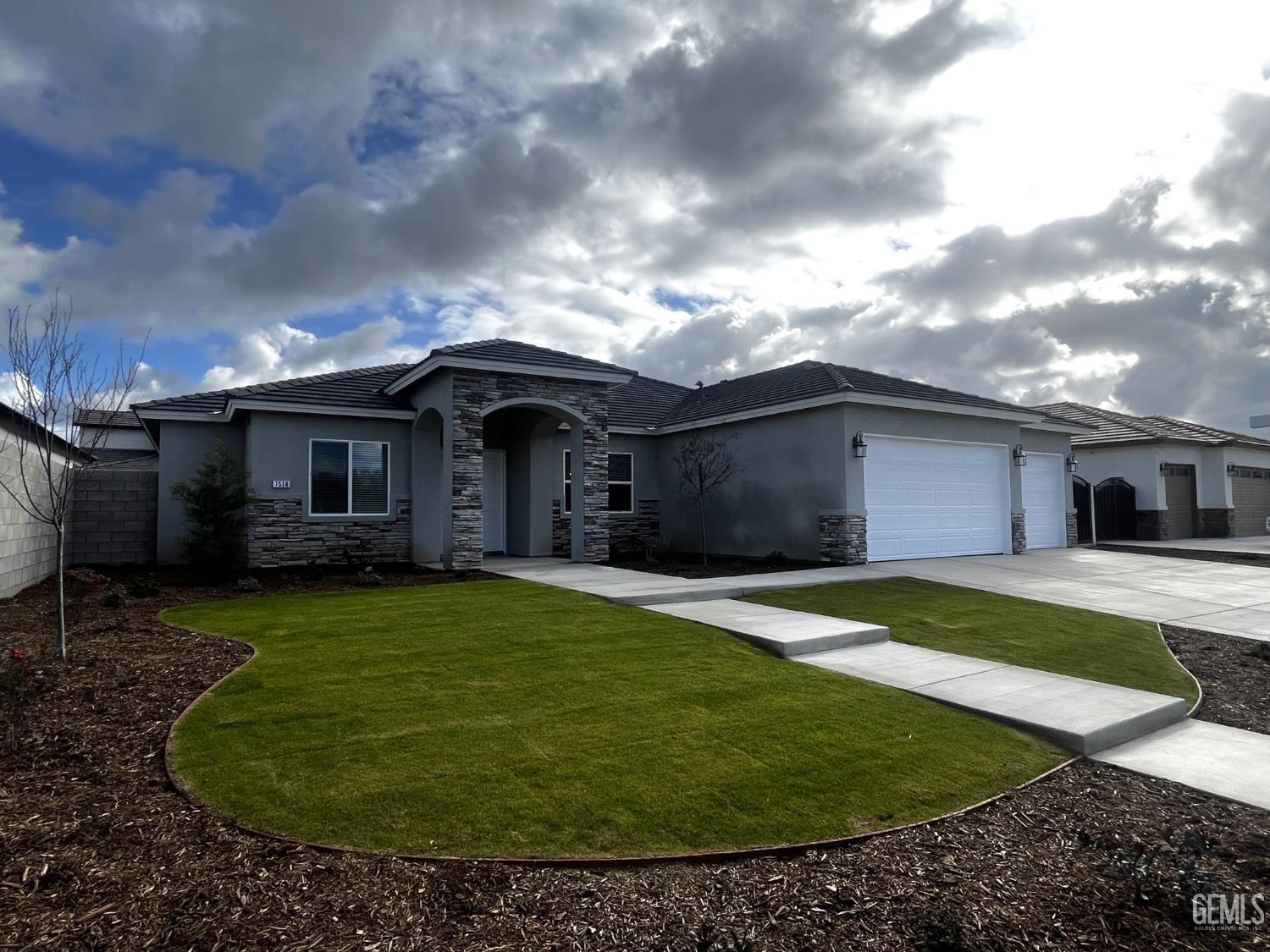 Undisclosed Address Bakersfield, CA 93314 - Photo 2 of 43 a front view of a house with a garden