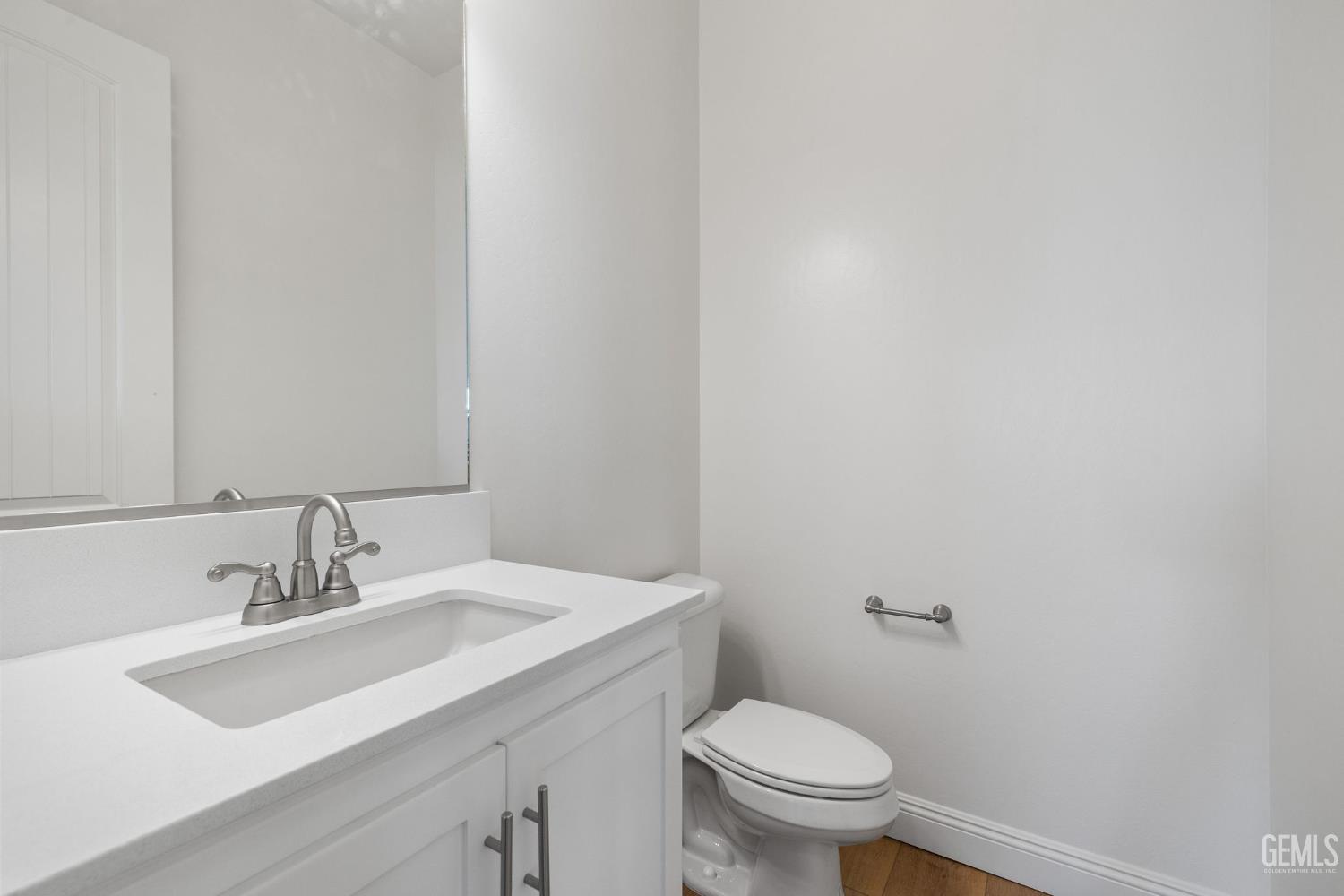 Undisclosed Address Bakersfield, CA 93314 - Photo 39 of 43 a bathroom with a sink a toilet and a mirror