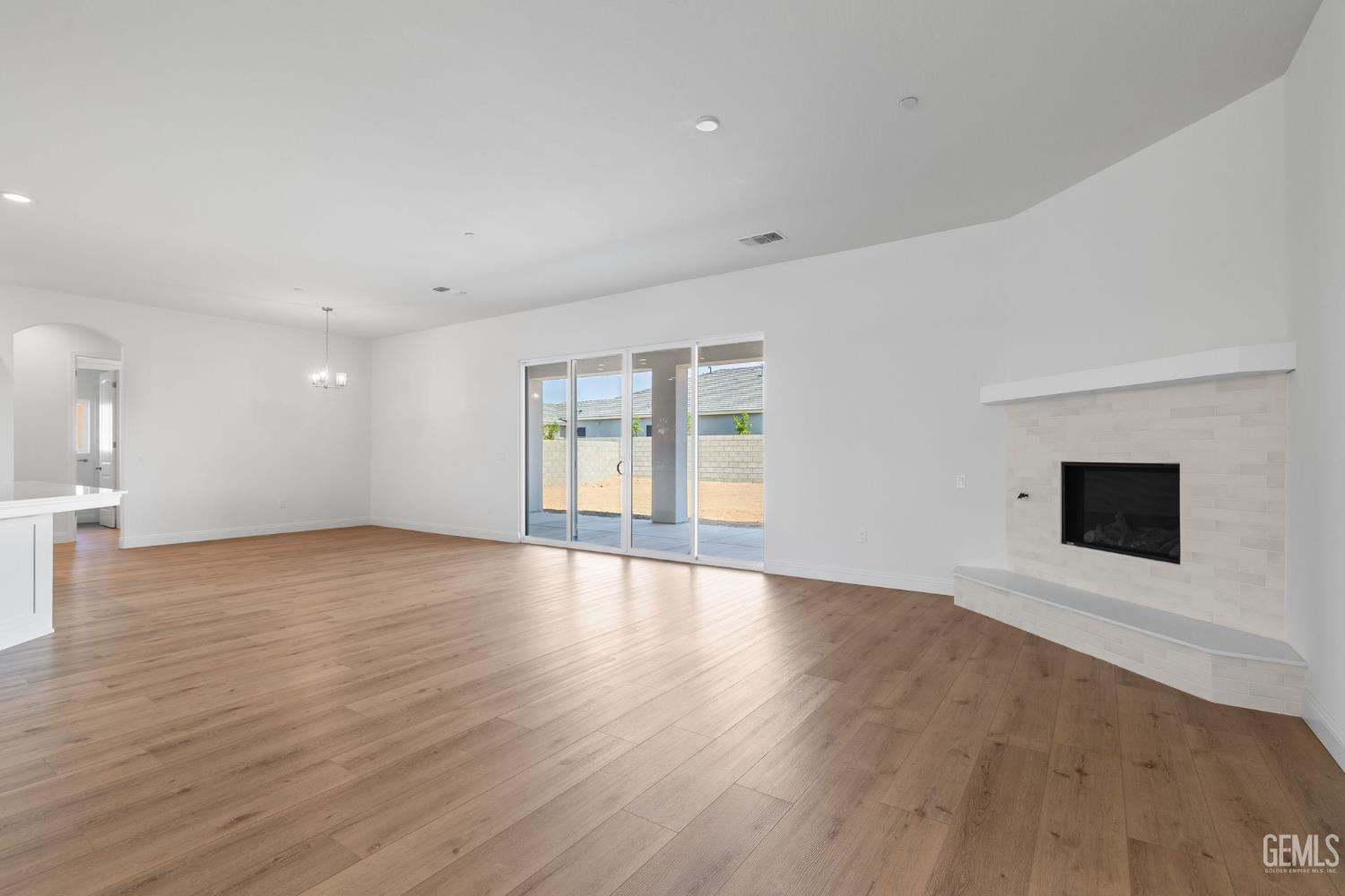 Undisclosed Address Bakersfield, CA 93314 - Photo 6 of 43 a view of an empty room with wooden floor and a fireplace