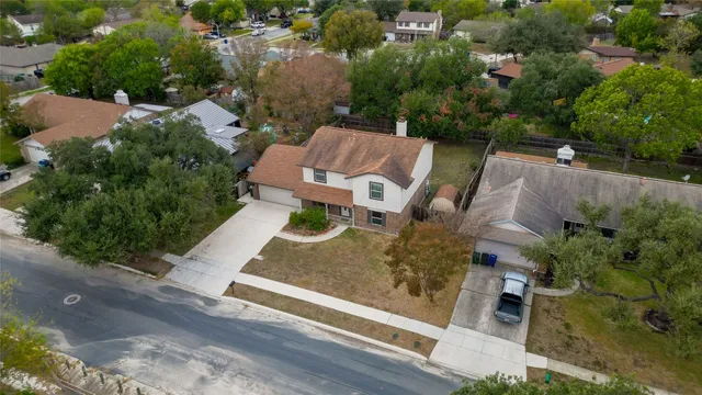 an aerial view of a house with garden space and street view