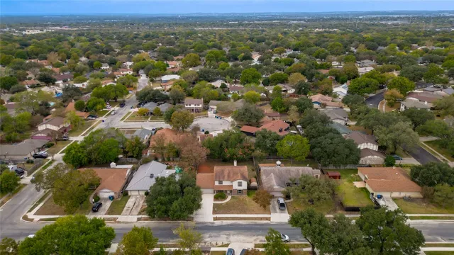 an aerial view of residential houses with city view