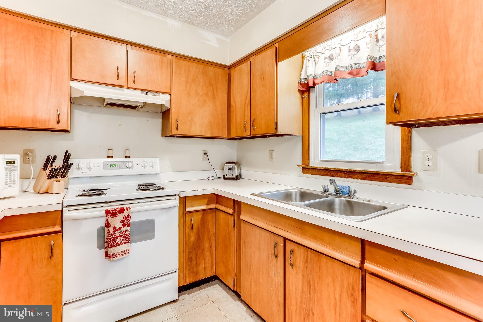 2229 Gablehammer Road Westminster, MD 21157 - Photo 12 of 30 a kitchen with stainless steel appliances a sink a stove and a refrigerator