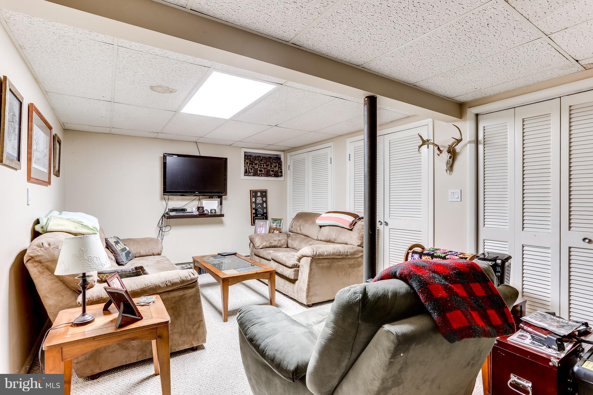 2229 Gablehammer Road Westminster, MD 21157 - Photo 22 of 30 a living room with furniture a flat screen tv and a window