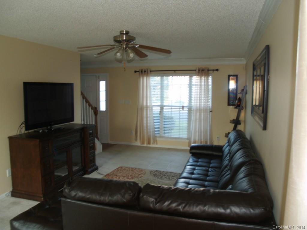 10402 Gold Pan Road Charlotte, NC 28215 - Photo 2 of 21 a living room with furniture and a flat screen tv