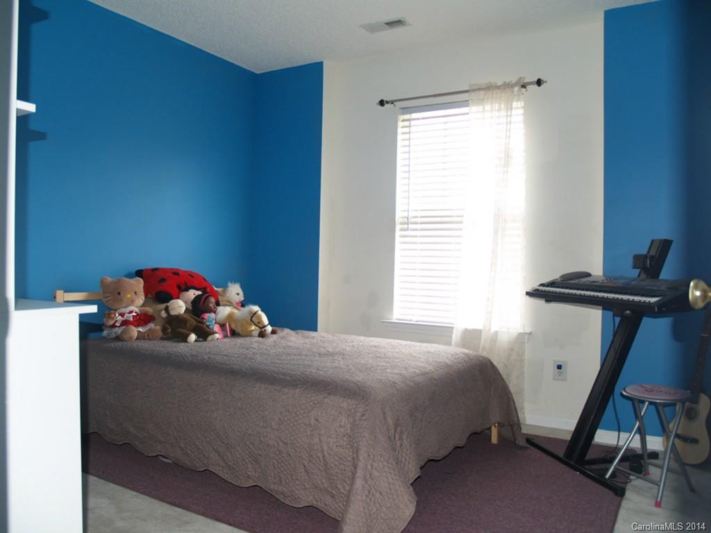 10402 Gold Pan Road Charlotte, NC 28215 - Photo 13 of 21 a bedroom with a bed and a window