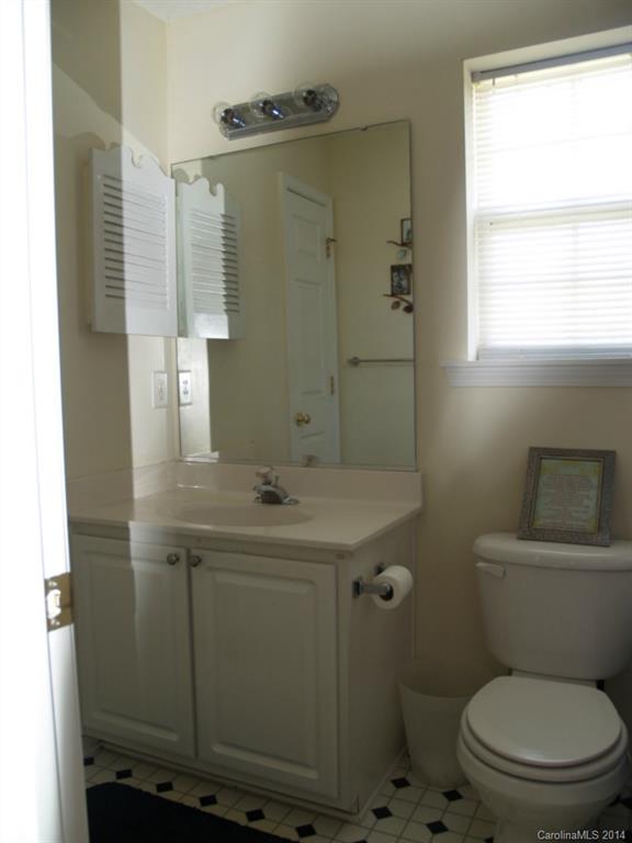 10402 Gold Pan Road Charlotte, NC 28215 - Photo 14 of 21 a bathroom with a sink a toilet and shower