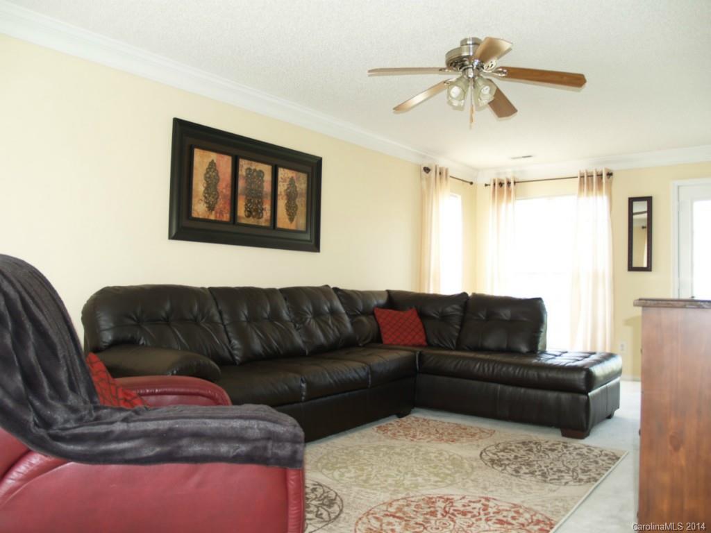 10402 Gold Pan Road Charlotte, NC 28215 - Photo 3 of 21 a living room with furniture and a ceiling fan