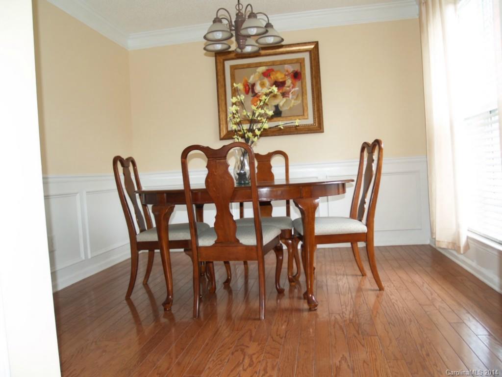 10402 Gold Pan Road Charlotte, NC 28215 - Photo 4 of 21 a view of a dining room with furniture and wooden floor