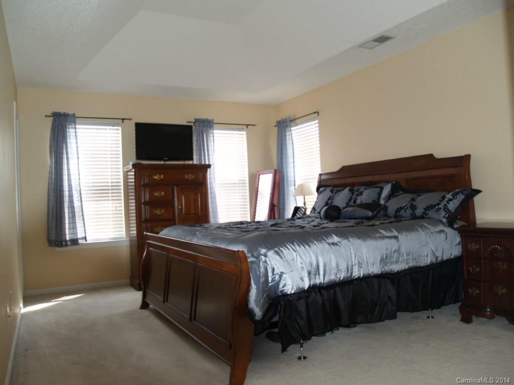 10402 Gold Pan Road Charlotte, NC 28215 - Photo 9 of 21 a bedroom with a bed and a television