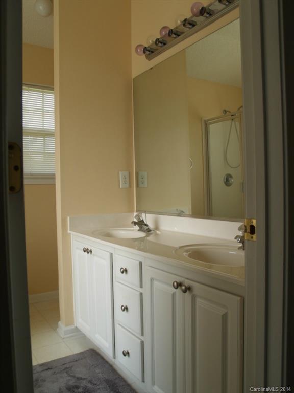 10402 Gold Pan Road Charlotte, NC 28215 - Photo 10 of 21 a bathroom with a granite countertop sink a mirror and a