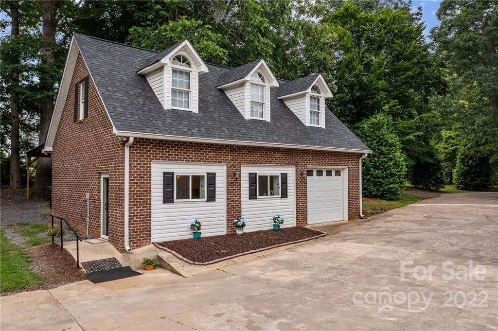 1215 Shive Road Salisbury, NC 28146 - Photo 15 of 48 a front view of a house with a yard and garage